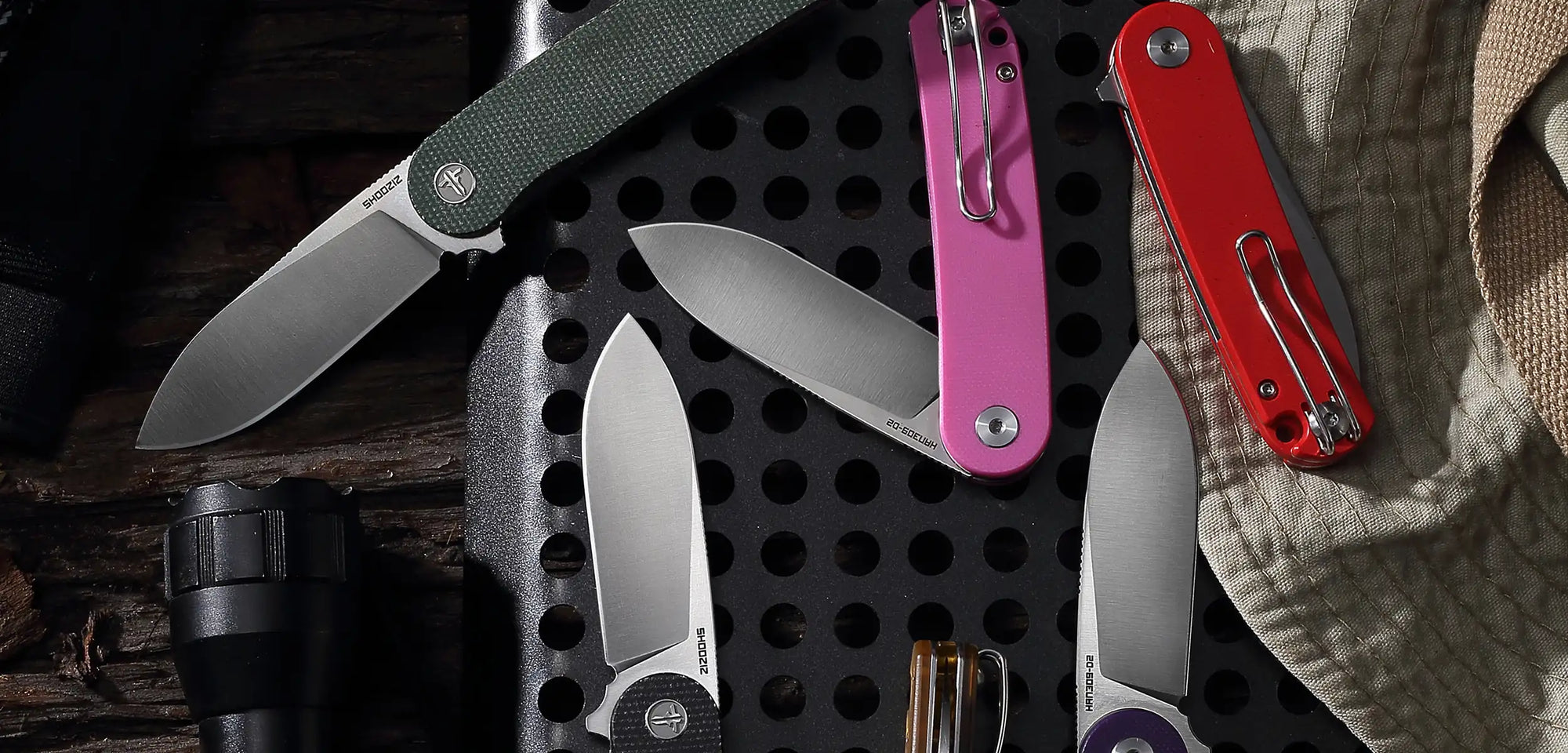 Desktop banner displaying multiple SHOOZIZ HAN309 folding knives from the original HAN Series. Satin D2 blades with carbon fiber, Micarta, and G10 handles. Classic everyday carry knives.