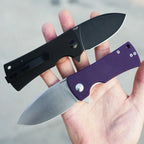 SHOOZIZ HAN306-BGB and PGS folding knives in hand, black G10 black PVD blade and purple G10 satin blade, EDC drop point tools.