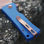 SHOOZIZ HAN306-LMRG closed folding knife detail, showing blue Micarta handle and rose gold PVD pocket clip.