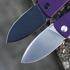 SHOOZIZ HAN306-PGS and PGB blade close-up on stone, purple G10 handles with satin and black PVD finishes.