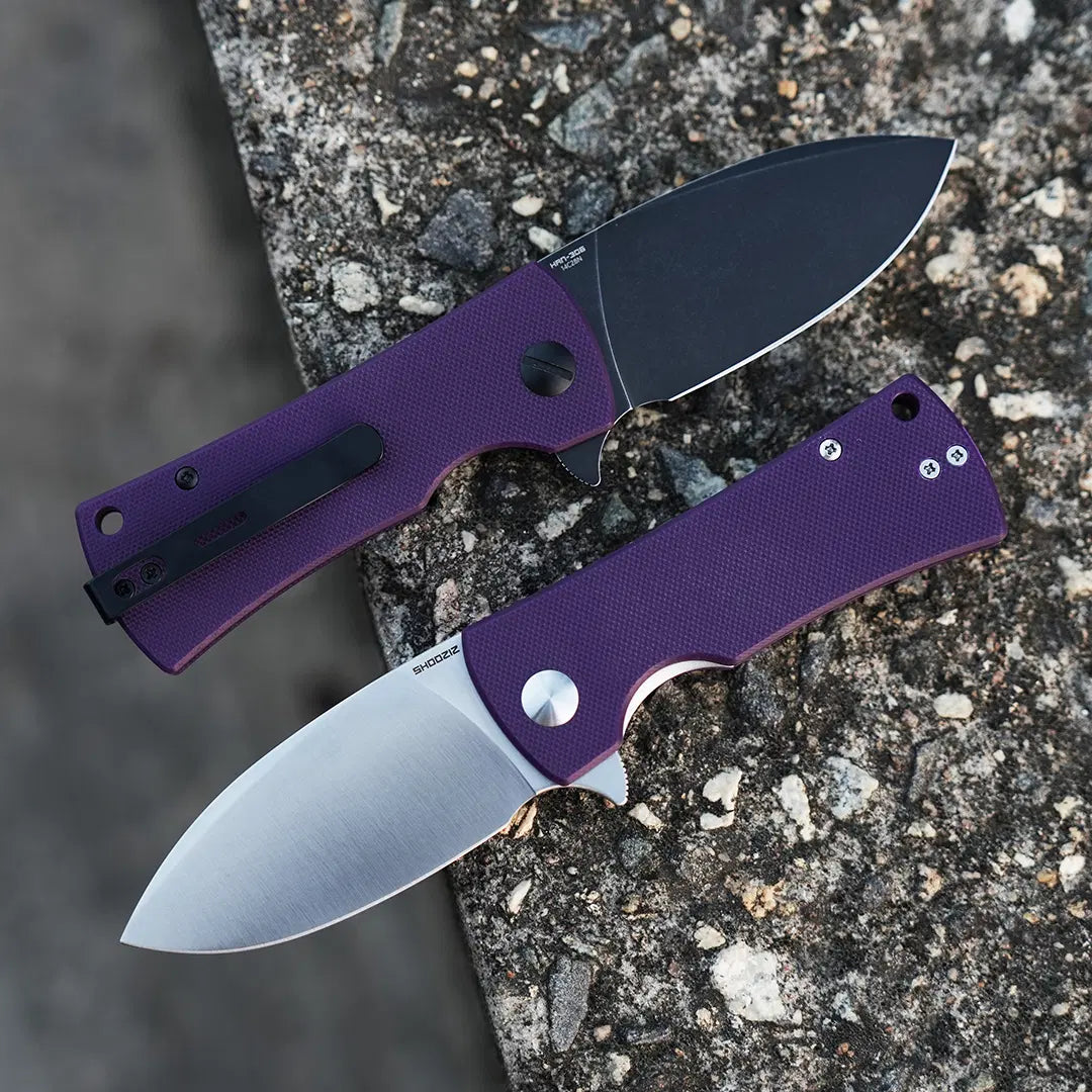 SHOOZIZ HAN306-PGS and PGB purple G10 folding knives open on stone, displaying satin and black PVD blades.