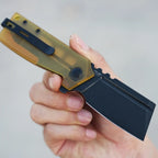 SHOOZIZ HAN307-JUB held in hand, showing black PVD 14C28N steel blade, translucent yellow Ultem handle, and black pocket clip.