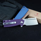 SHOOZIZ HAN307-PGS purple G10 knife open and HAN307-LMRG blue Micarta knife closed, displayed with tactical gloves and a SHOOZIZ box on black background.