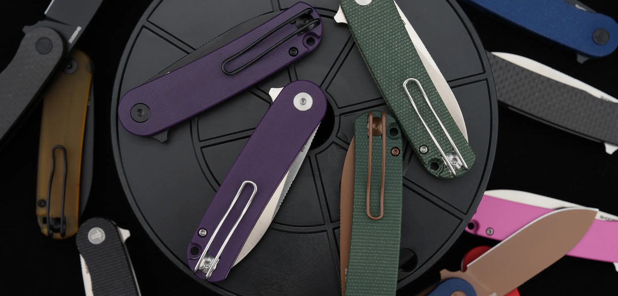 Desktop banner showcasing multiple SHOOZIZ HAN309 series folding knives with new Rose Gold PVD blade finishes (BMB, LMRG, LMB, LGS, GMRG, PGB) and Micarta or G10 handles. A collection of premium EDC knives for everyday carry.