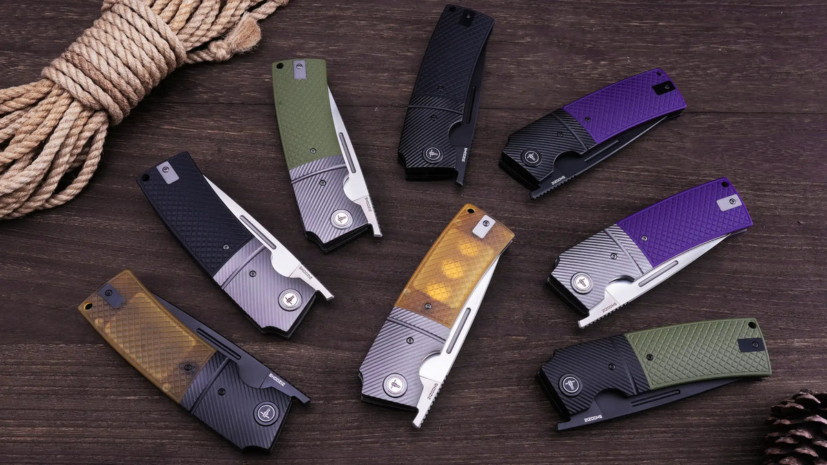 Full SHOOZIZ XUN120 series collection on a wooden table, featuring G10, Micarta, Ultem, and carbon fiber pattern handles with satin and black PVD finishes.