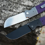 SHOOZIZ XUN122-PGS satin and PGB black PVD folding knives open on stone, purple G10 handles.