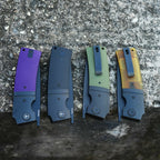 SHOOZIZ XUN122 black PVD models lineup closed, featuring purple G10, black G10, green G10, and Ultem handles with black steel bolsters.